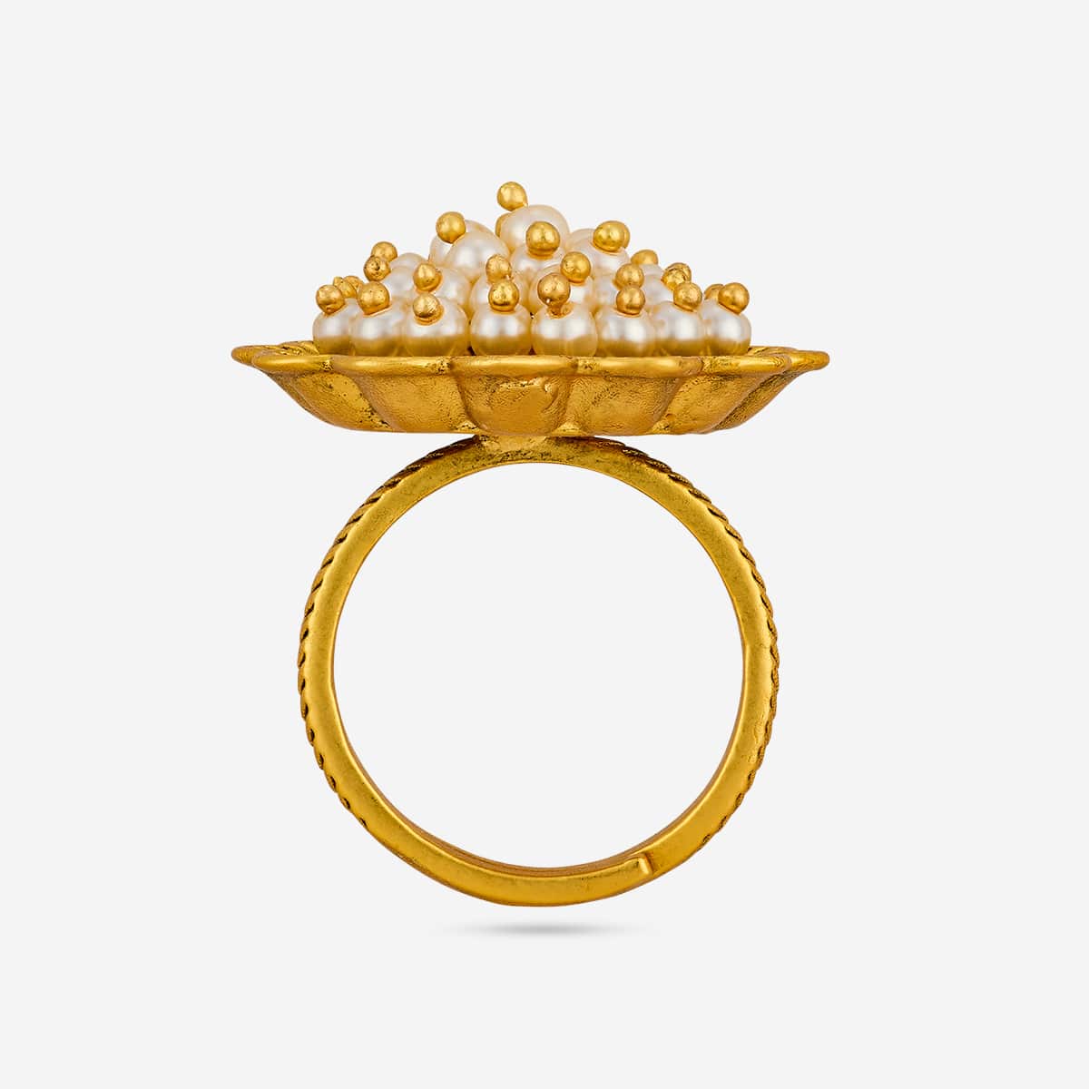 Side view of antique finger ring with pearl-like cluster on gold-tone band.