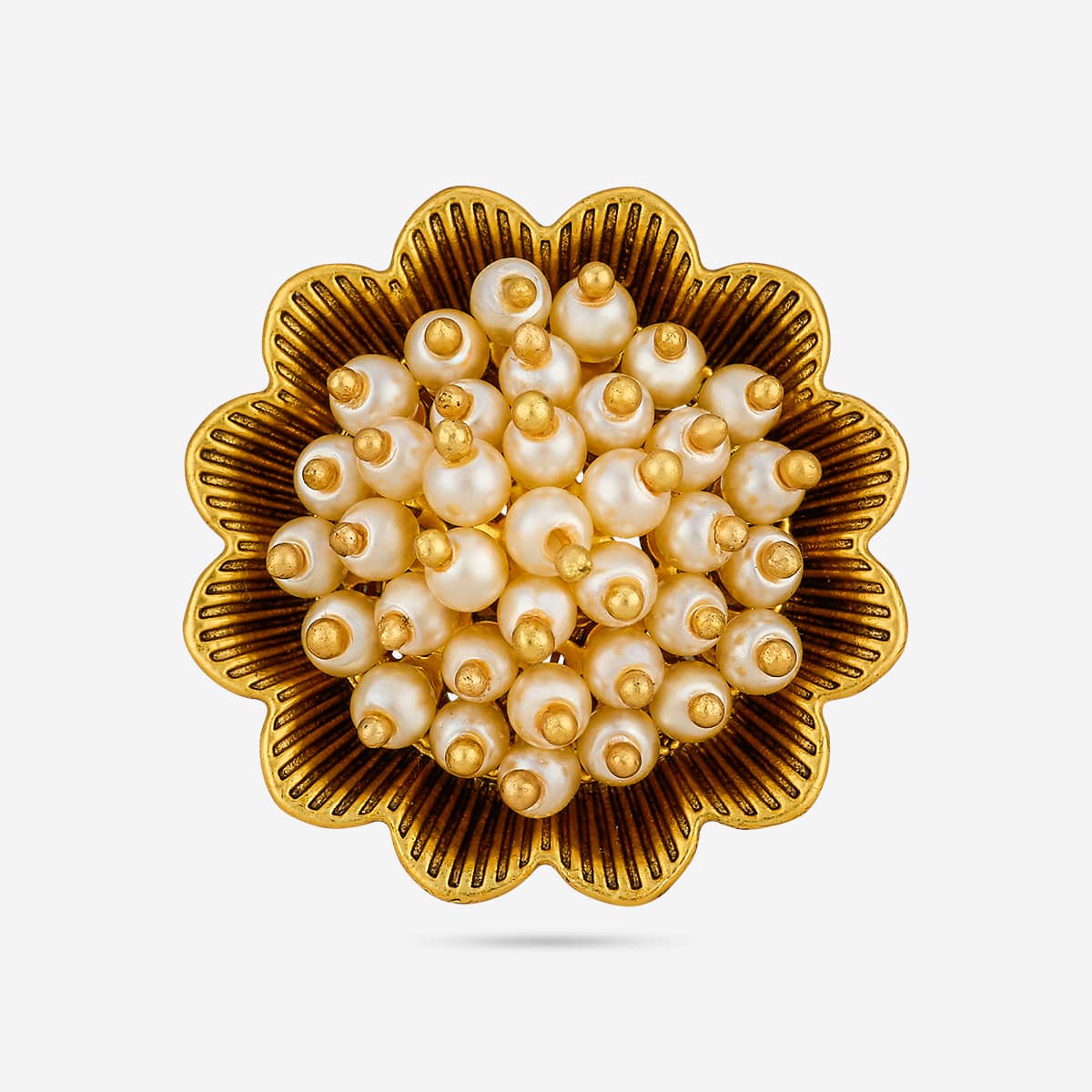 Close-up of antique finger ring showing pearl-like cluster on gold-tone floral design.