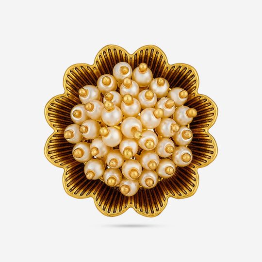 Close-up of antique finger ring showing pearl-like cluster on gold-tone floral design.
