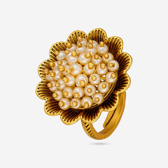 Antique finger ring with pearl-like cluster on gold-tone floral base, front view.
