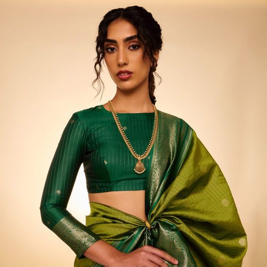 Model wearing antique long haar necklace with teardrop pendant and white pearls.