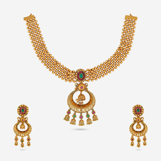 Antique necklace set with ruby-red and green stones, displayed on a white background.