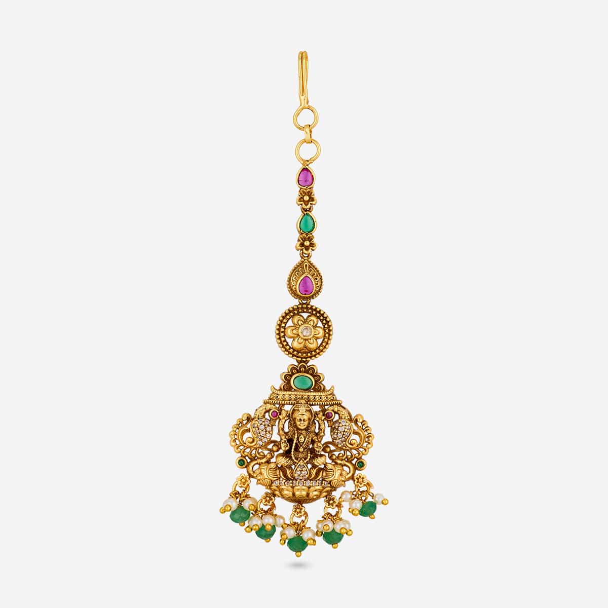 Antique tikka with deity motif, green and pink stones, on white background.