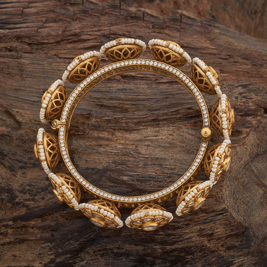 Top view of antique floral Kundan bangle with intricate design.