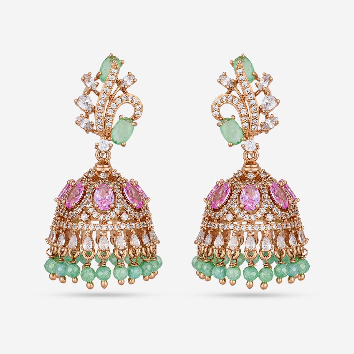 Gold-tone zircon jhumka earrings with green and pink stones, on white background.