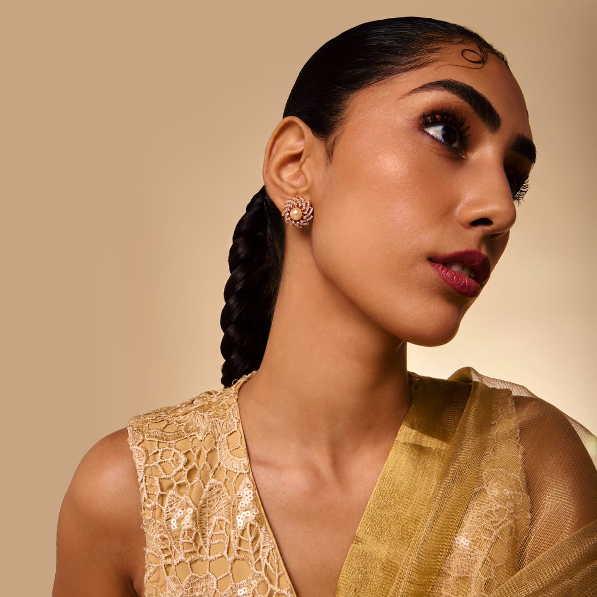 Rose gold-tone zircon stud earring with floral motif, worn by a model.