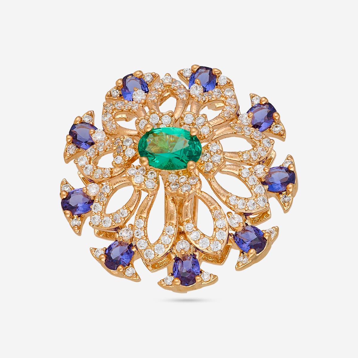 Gold-tone finger ring with green center stone and blue accents, top view.
