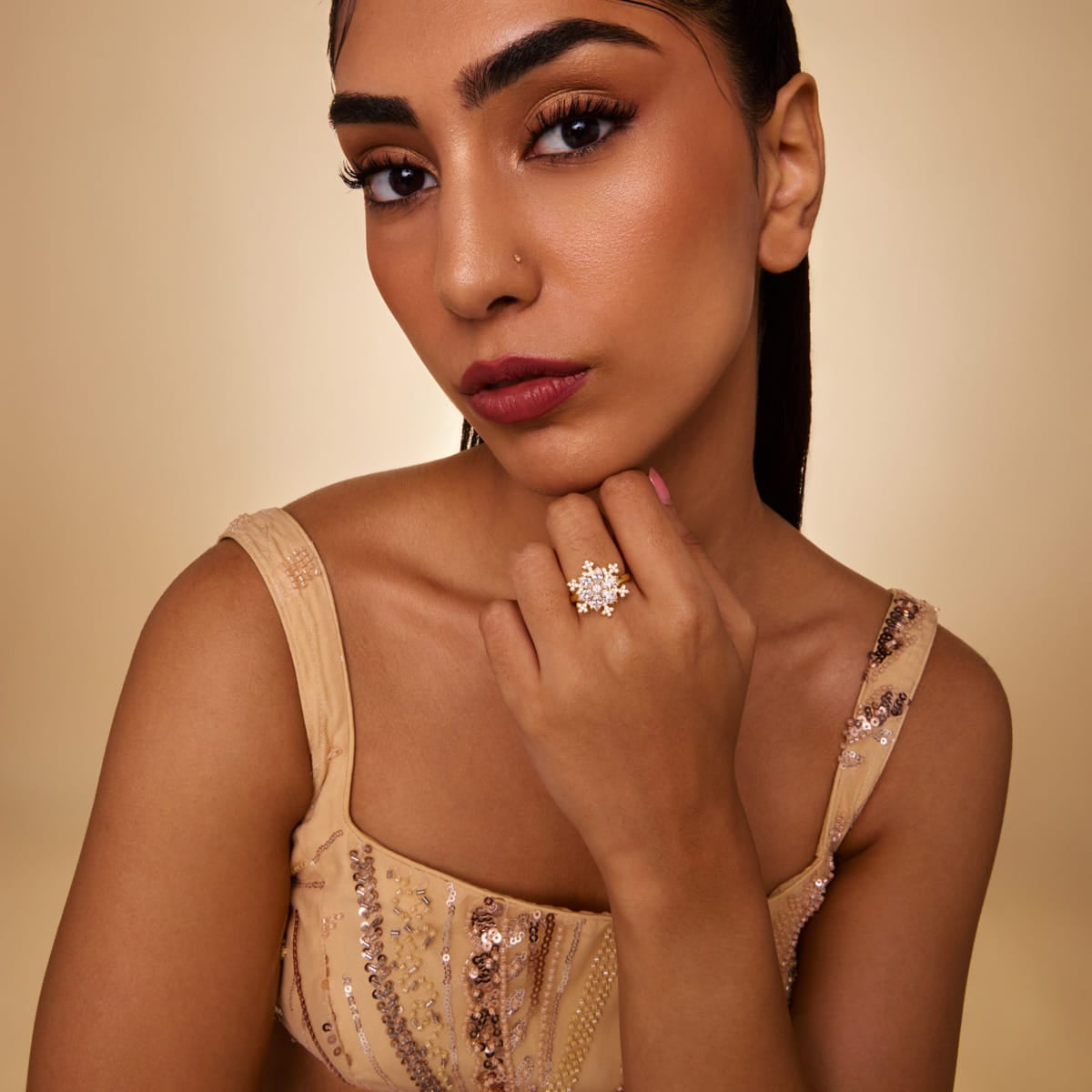 Gold-tone zircon cluster ring with clear stones, worn by model.