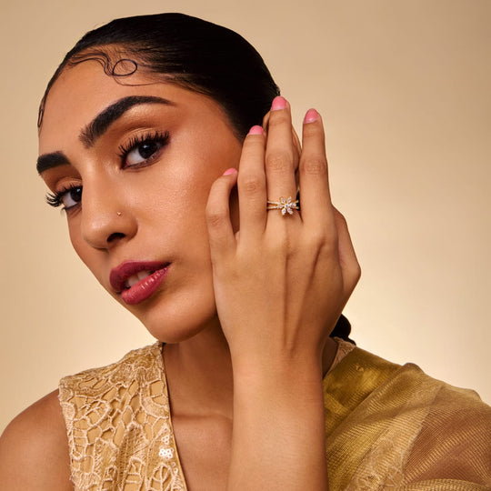 Gold-tone zircon cluster ring with clear stones worn by a model.