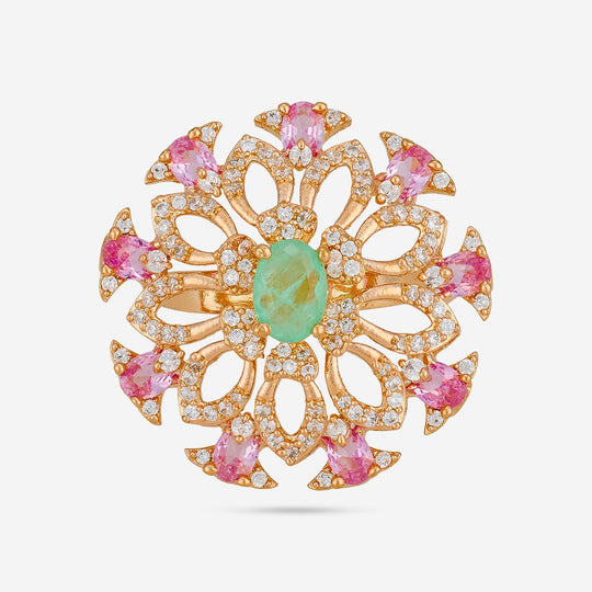 Gold-tone finger ring with green center stone and pink accents, front view.