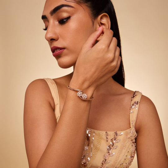 Gold-tone zircon kada with star cluster design, worn by a model.