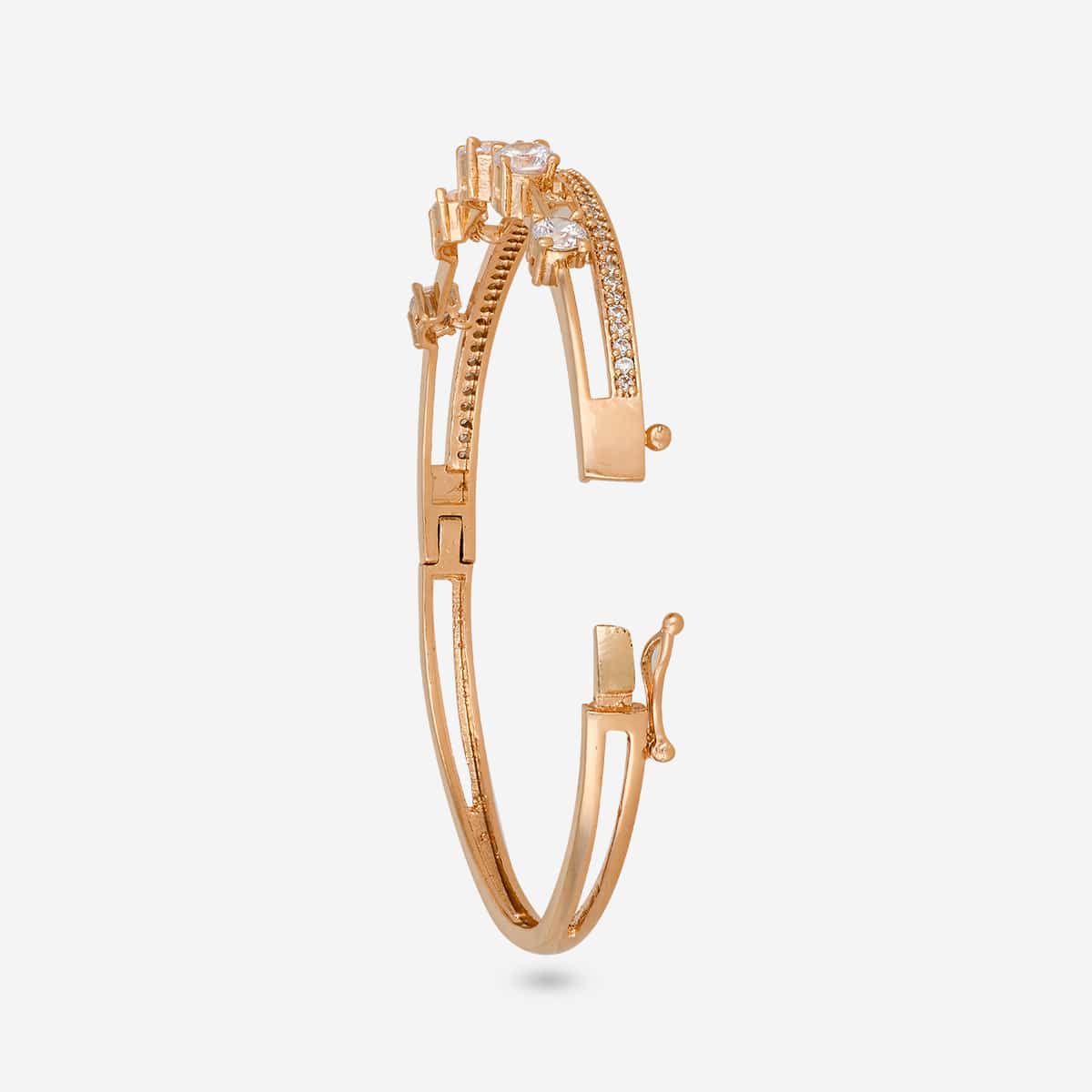 Gold-tone zircon kada with white stones, open clasp side view.