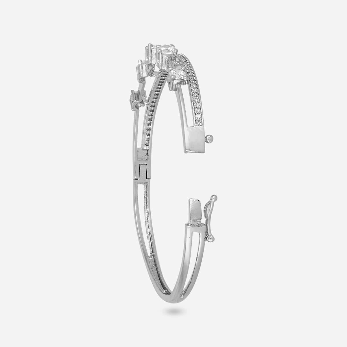 Silver-tone zircon kada with white stones, open clasp side view.