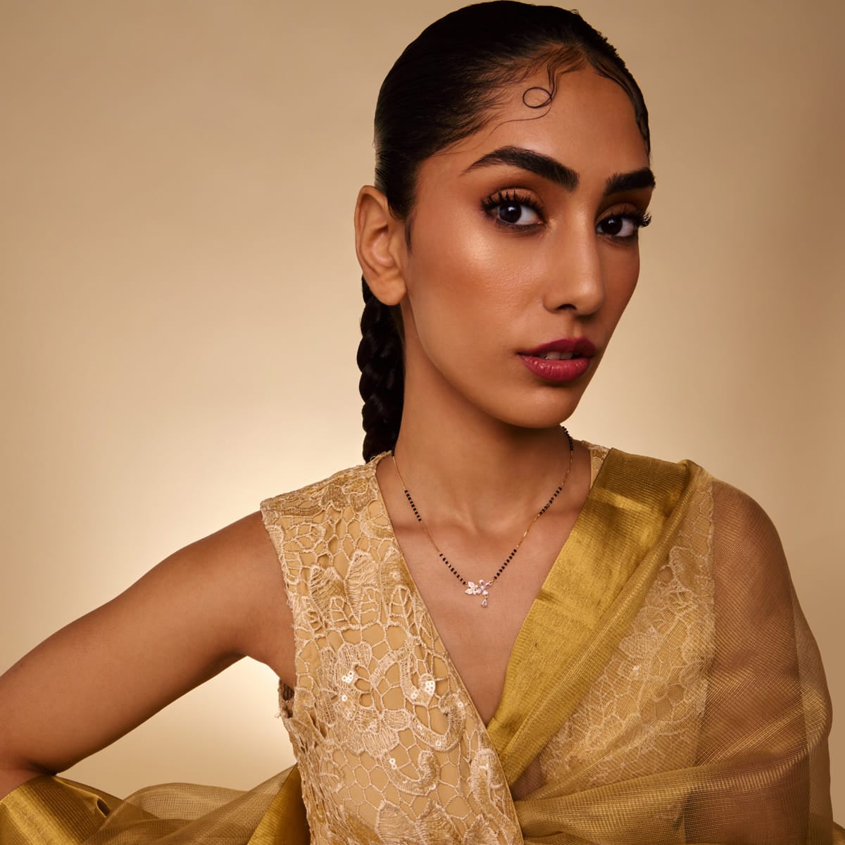 Model wearing zircon mangalsutra with clear stones and drop pendant.