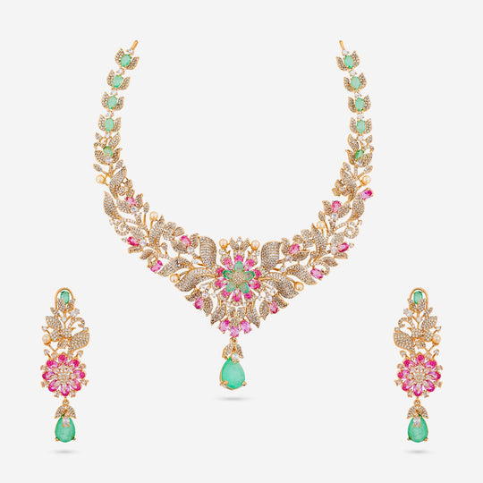 Kundan zircon necklace and earrings with pink and mint stones on white background.