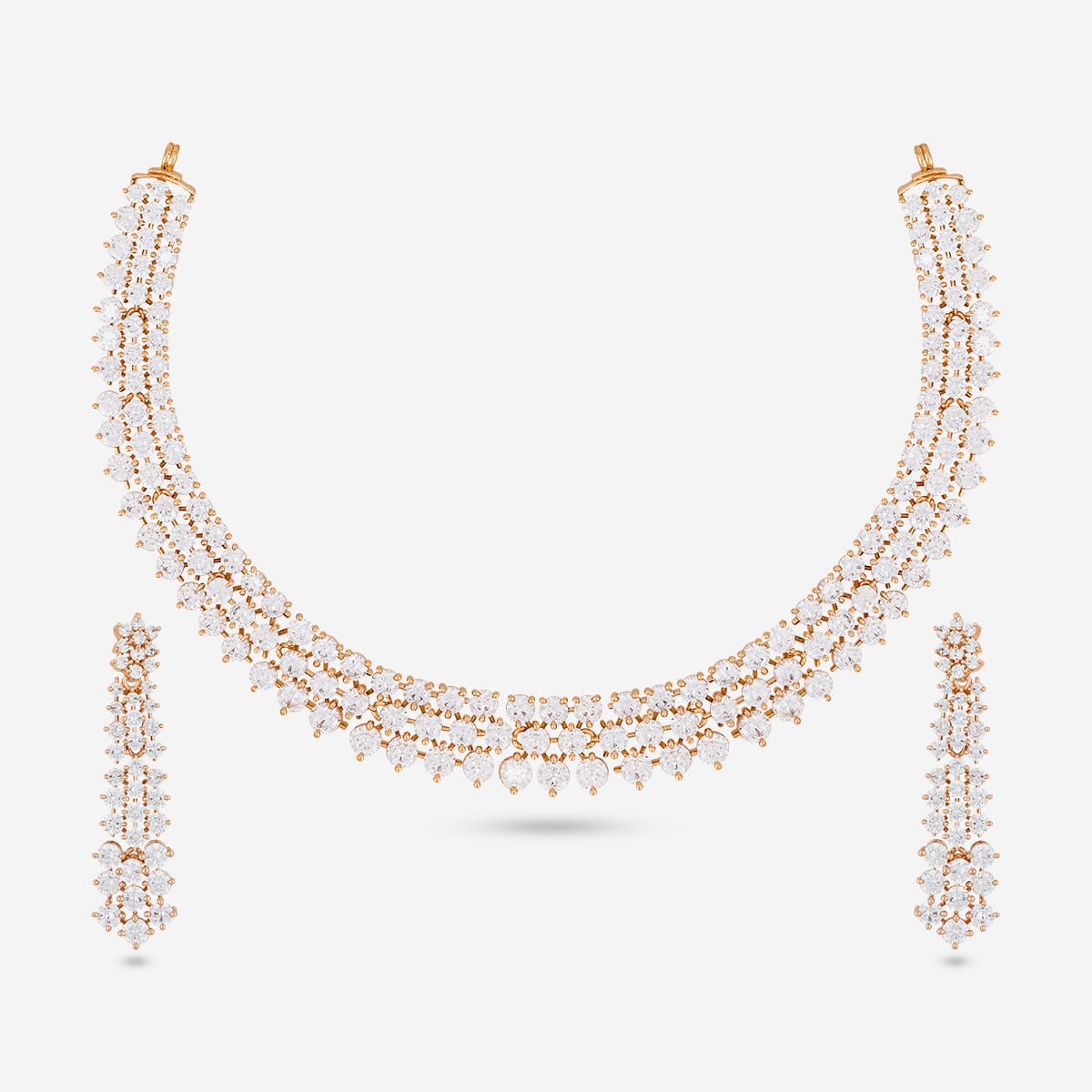 Gold-tone zircon necklace set with white stones on a white background.