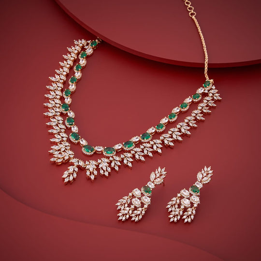 Green zircon collar necklace and earrings set on red surface.