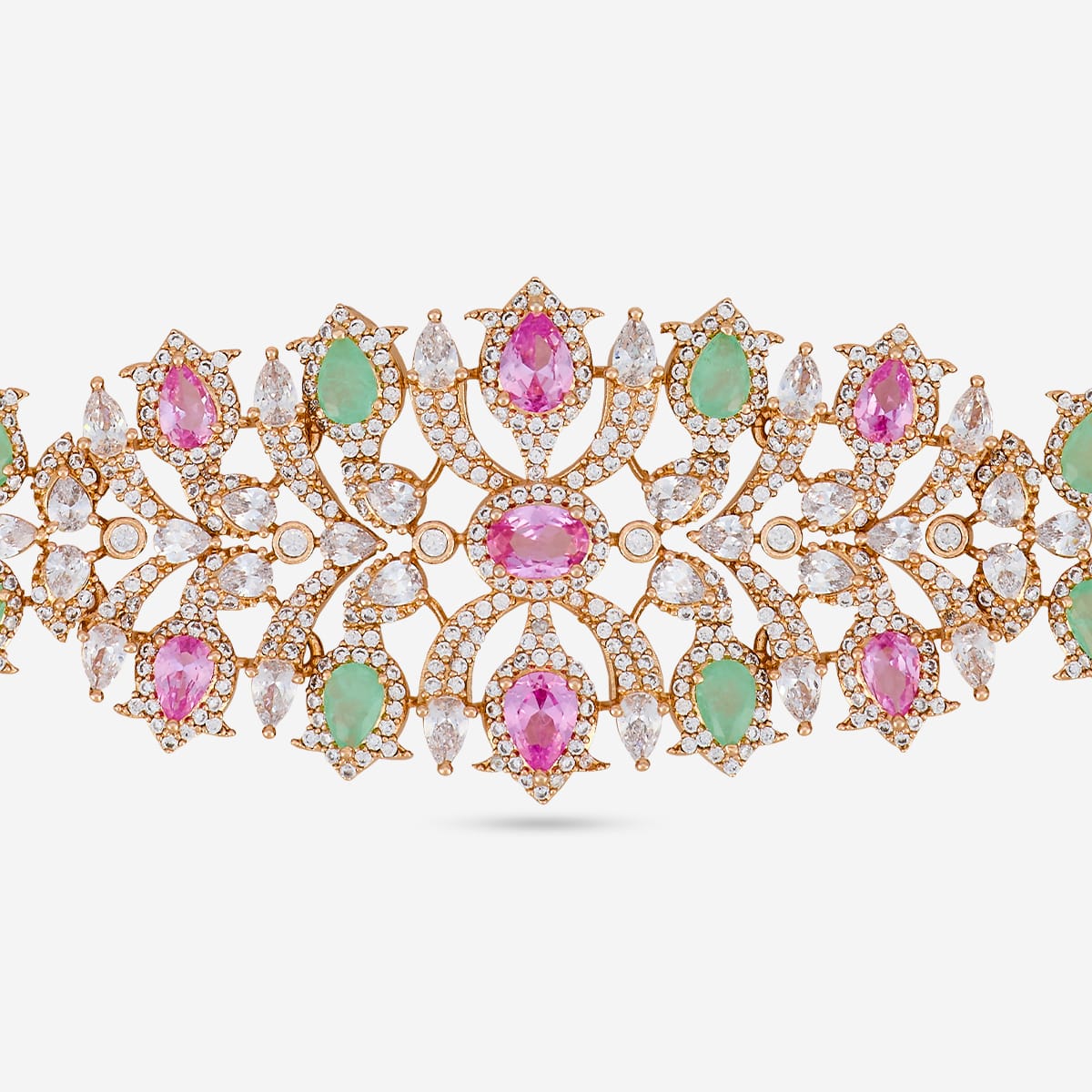 Close-up of zircon necklace with pink and green stones and intricate design.