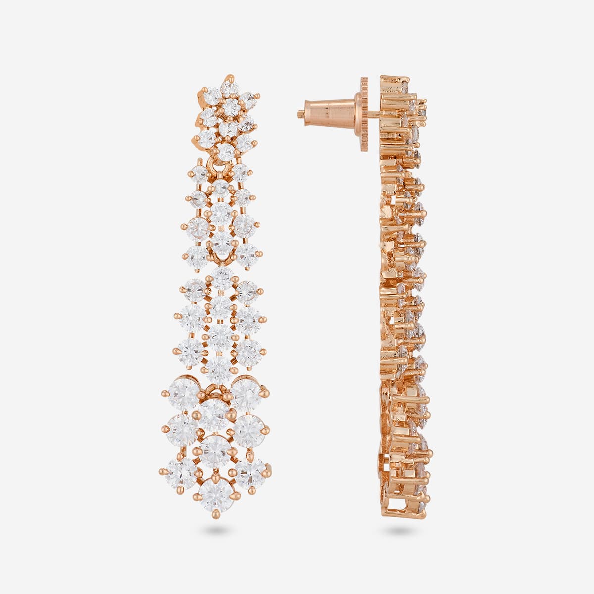 Close-up of gold-tone zircon earrings with white stones, side and front view.