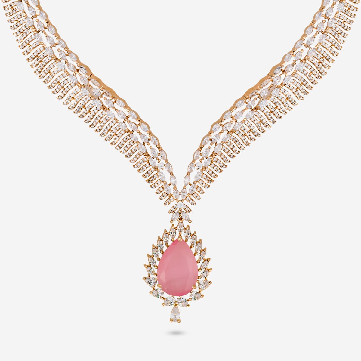 Close-up of zircon necklace with pink stone and white stones.