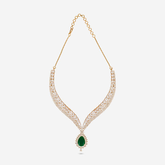 Zircon necklace with green stone and white stones on white background.