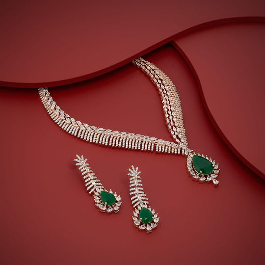 Zircon necklace set with green stones displayed on red surface.