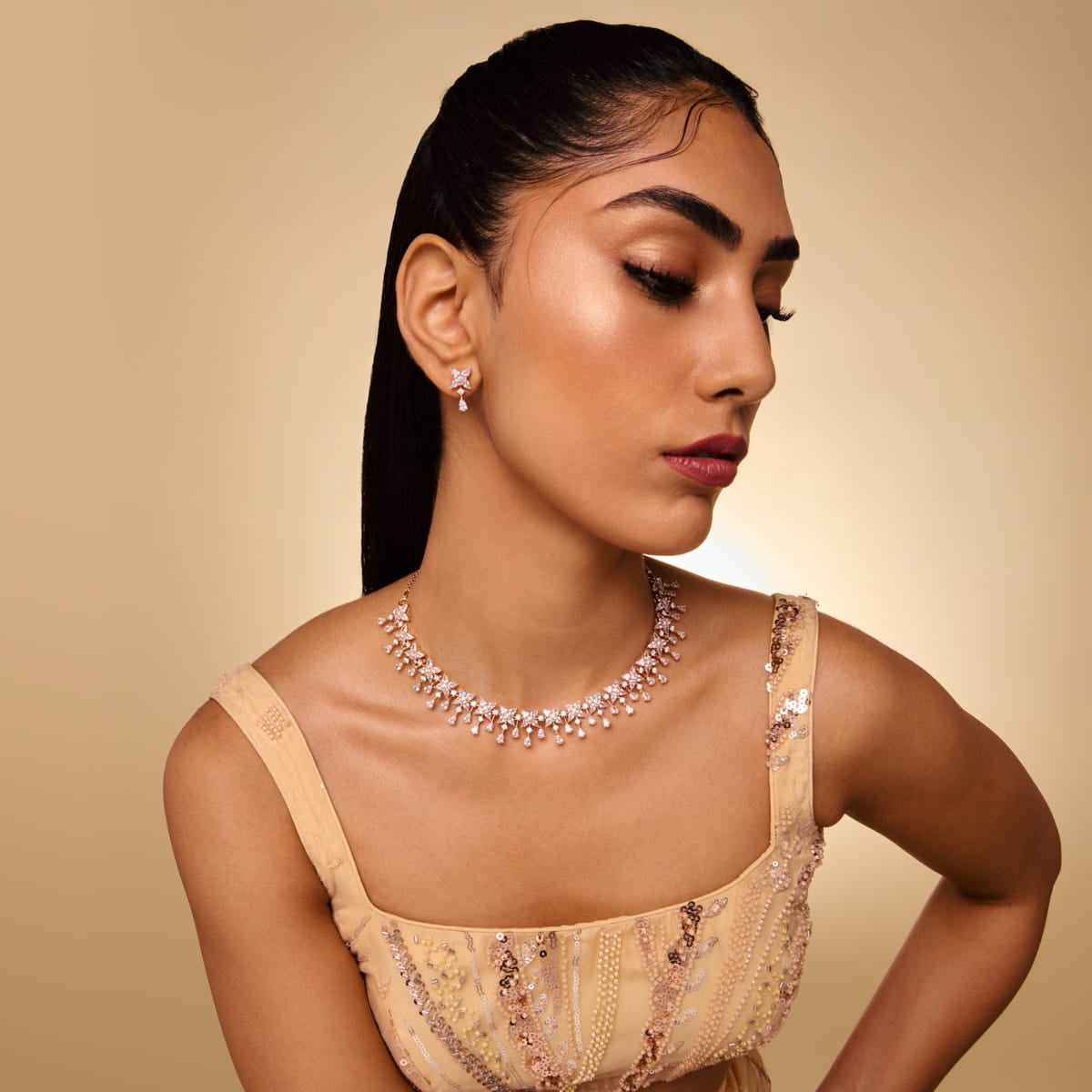 Model wearing zircon necklace and earrings set with star and pear shapes.